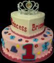 Princess of My Heart 1st Birthday Cake. Pink and white buttercream iced, round and heart shaped 2 tier, decorated with butterflies, hearts, flowers, stars and pearls. Topped with a rhinestone crown. Everything on this cake is EDIBLE except the crown. (Serves 28-55 party slices) 